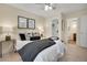Bedroom features a ceiling fan, neutral walls, closet, and a view to the en-suite bathroom at 9160 E Arbor Cir # F, Englewood, CO 80111