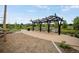 Charming community park with swinging bench seating and a paved walking path at 9160 E Arbor Cir # F, Englewood, CO 80111