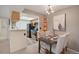 Dining area adjacent to the kitchen with modern light fixture at 9160 E Arbor Cir # F, Englewood, CO 80111