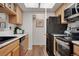 The kitchen features wood cabinets, stainless steel appliances, and a pass-through to the laundry room at 9160 E Arbor Cir # F, Englewood, CO 80111