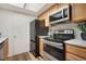 This kitchen features stainless steel appliances, including an oven and microwave at 9160 E Arbor Cir # F, Englewood, CO 80111