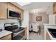 The kitchen has stainless steel appliances and light wood cabinets that open to the dining room at 9160 E Arbor Cir # F, Englewood, CO 80111