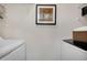 This laundry room features a washer, dryer, shelves, and an art piece at 9160 E Arbor Cir # F, Englewood, CO 80111
