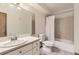 Bathroom with white cabinets, shower-tub combo and tiled floors at 3315 S Ammons St # 111, Lakewood, CO 80227