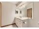 Bathroom with white vanity, modern lighting, and large mirror at 3315 S Ammons St # 111, Lakewood, CO 80227