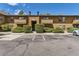 Cozy two-story townhouse featuring assigned parking, mature landscaping, and private entrances at 3315 S Ammons St # 111, Lakewood, CO 80227