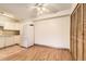 Well-lit kitchen area with white appliances, storage cabinets, and an adjacent dining space at 3315 S Ammons St # 111, Lakewood, CO 80227
