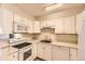 Efficient kitchen with white appliances, ample cabinet space, and a bright, clean design at 3315 S Ammons St # 111, Lakewood, CO 80227