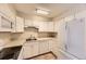 Bright kitchen with white cabinets, modern appliances, and functional layout for cooking at 3315 S Ammons St # 111, Lakewood, CO 80227