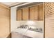Bright laundry room with washer, dryer, and storage cabinets at 3315 S Ammons St # 111, Lakewood, CO 80227
