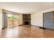 Inviting living room with wood floors, stone fireplace, and access to a private patio at 3315 S Ammons St # 111, Lakewood, CO 80227
