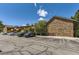 Exterior parking lot view showcases building with brick and siding and several parked cars at 3315 S Ammons St # 111, Lakewood, CO 80227