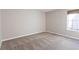 Neutral bedroom featuring carpet, base trim, and a window providing natural light at 6420 E Bates Ave, Denver, CO 80222