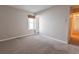 This bedroom features neutral tones, a window, and an adjacent closet at 6420 E Bates Ave, Denver, CO 80222