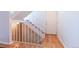 Bright entryway featuring hardwood floors, a staircase with white railings, and a white entry door at 6420 E Bates Ave, Denver, CO 80222