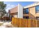 Exterior elevation of home with brick and wood detail and tile roof at 6420 E Bates Ave, Denver, CO 80222
