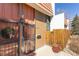 Close-up of the secured entryway with tile roof, metal gate and pot at 6420 E Bates Ave, Denver, CO 80222