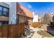Home exterior showing the secured entry, tile roof, and privacy fence at 6420 E Bates Ave, Denver, CO 80222