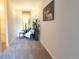 Hallway nook with accent chair, throw blanket, throw pillow, wall art, side table, lamp, and plant at 6420 E Bates Ave, Denver, CO 80222