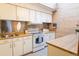 Functional kitchen with bright white appliances and wood countertops at 6420 E Bates Ave, Denver, CO 80222