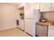 Functional laundry room with a washer, dryer, fridge, and shelving at 6420 E Bates Ave, Denver, CO 80222