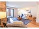 Comfortable living room featuring a stone fireplace and sliding glass door at 6420 E Bates Ave, Denver, CO 80222