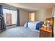 Bright main bedroom featuring a large window with curtains and a comfortable bed with stylish linens at 6420 E Bates Ave, Denver, CO 80222