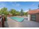 Community pool surrounded by mature trees and lounge seating at 6420 E Bates Ave, Denver, CO 80222