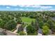 A lush aerial view showcases a neighborhood with mature trees, expansive green spaces, and nearby urban amenities at 8663 E Davies Ave, Centennial, CO 80112