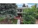 A view of the back of the home showcasing a large wood deck and second-story balcony at 8663 E Davies Ave, Centennial, CO 80112