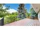 Relaxing on the wooden deck offers serene backyard views, blending nature and comfortable outdoor living at 8663 E Davies Ave, Centennial, CO 80112