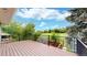 Backyard wooden deck offers expansive views of the surrounding green space, perfect for relaxing at 8663 E Davies Ave, Centennial, CO 80112