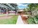 Landscaped backyard featuring a spacious wooden deck, lush green lawn, and mature trees providing shade at 8663 E Davies Ave, Centennial, CO 80112