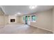 Finished basement with a fireplace, sliding glass door to a deck, and plush carpet at 8663 E Davies Ave, Centennial, CO 80112