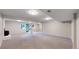 Spacious finished basement featuring plush carpet, fireplace, and sliding glass doors at 8663 E Davies Ave, Centennial, CO 80112