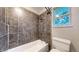 Bathroom boasting tiled shower, updated fixtures and great lighting at 8663 E Davies Ave, Centennial, CO 80112
