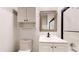 Well-lit bathroom with a modern vanity, toilet, and shower behind glass doors at 8663 E Davies Ave, Centennial, CO 80112
