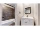 Bathroom featuring tiled shower with modern vanity and fixtures at 8663 E Davies Ave, Centennial, CO 80112