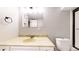 Well-lit bathroom features a vanity with a marble countertop and modern fixtures at 8663 E Davies Ave, Centennial, CO 80112