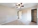 Bright bedroom featuring neutral walls, carpet, a ceiling fan, and closet at 8663 E Davies Ave, Centennial, CO 80112