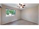 Bedroom with neutral walls, carpet flooring, and window views at 8663 E Davies Ave, Centennial, CO 80112