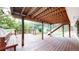 Underneath the wooden deck, enjoy outdoor living with support beams and a view of the lush backyard at 8663 E Davies Ave, Centennial, CO 80112