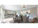 Bright dining area with hardwood floors and view into an adjacent living room and modern kitchen at 8663 E Davies Ave, Centennial, CO 80112