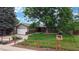 Inviting single-story home with a well-maintained front lawn, complemented by a charming red fence at 8663 E Davies Ave, Centennial, CO 80112