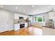 Well-lit kitchen includes stainless steel appliances and wood flooring at 8663 E Davies Ave, Centennial, CO 80112