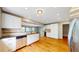 Bright kitchen features wood floors, stainless steel appliances, and stylish backsplash at 8663 E Davies Ave, Centennial, CO 80112