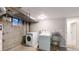 Spacious laundry room with modern washer and dryer, plus a utility sink for added convenience at 8663 E Davies Ave, Centennial, CO 80112