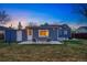 Inviting backyard with lawn, stone patio, and chairs, perfect for outdoor entertaining and relaxation at 4720 Perry St, Denver, CO 80212
