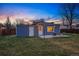 Charming backyard with well-maintained lawn, patio, and cozy seating area with string lights at 4720 Perry St, Denver, CO 80212