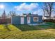 Landscaped backyard features a patio, outdoor seating, string lights, and grass, perfect for relaxing at 4720 Perry St, Denver, CO 80212